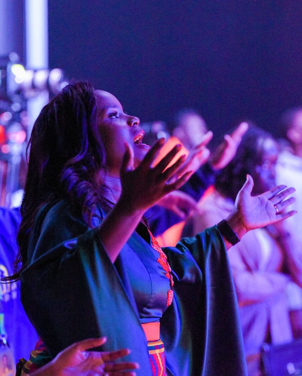 Purity Atieno raising her arms high